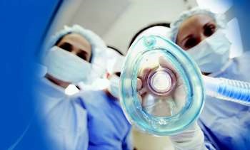 Surgeons Performing Operation --- Image by © Royalty-Free/Corbis